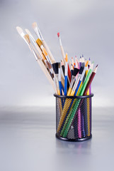 Set of art tools on a chrome background.
