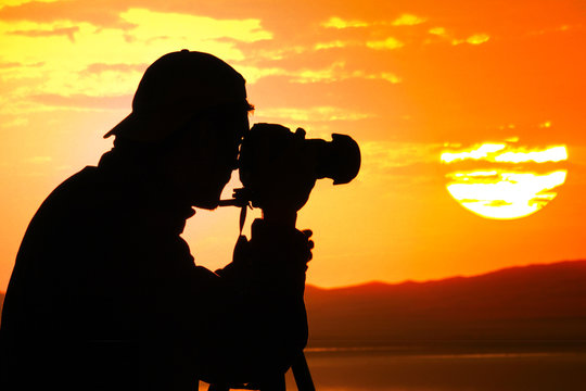 Photographer silhouette at sunset