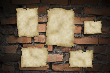 Old blank papers on brick wall