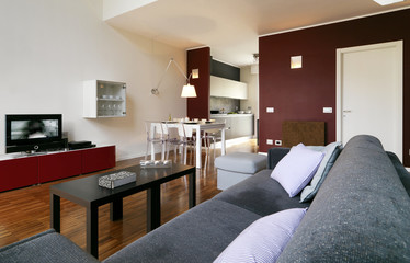 moderna sala da pranzo con vista cucina e divano