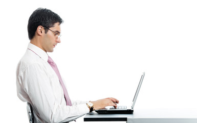 Portrait of businessman working with laptop, isolated