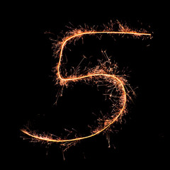 Digit 5 made of sparklers isolated on black