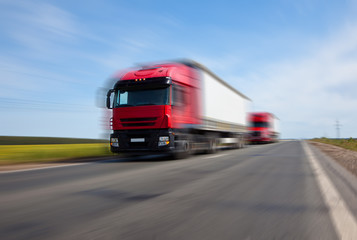 two red trucks blurred motion
