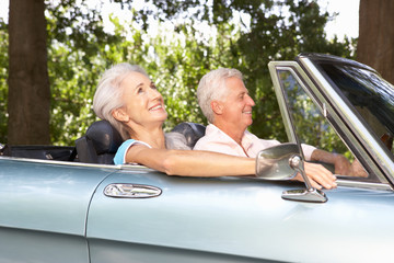 Senior couple in sports car