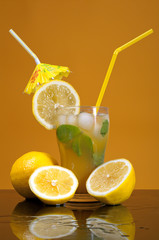 citrus coctail drink with ice cubs