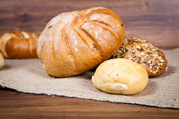 Composition of fresh bread on wood