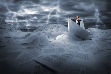 Businessman sailing in stormy papers sea
