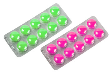 Two metallic blister with purple and green pills