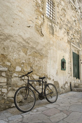 Fototapeta na wymiar A bicycle parcked by church ruins