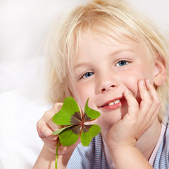 Cute blond girl has luck with shamrock