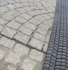 old tire rolled out on cobble-stone road