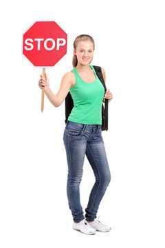 Young Woman Holding A Traffic Sign Stop