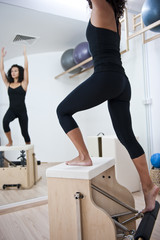 Attractive young lady doing pilates