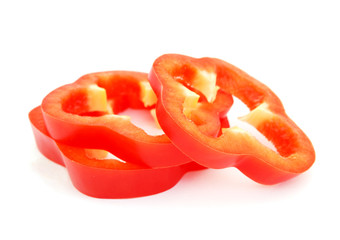Slices of red bell pepper isolated on white background