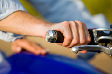 A close up of a man holding a motorbike handle