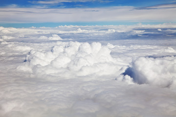 Obraz premium Aerial view of dense clouds bathed in sunshine.