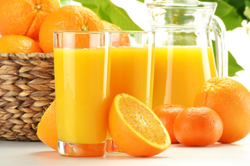 Composition with two glasses of orange juice and fruits
