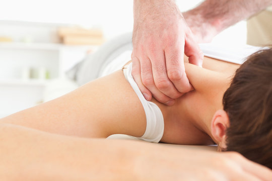 Brunette Woman getting a neck-massage