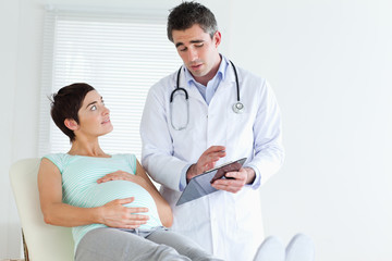 Doctor explaining something to a pregnant woman