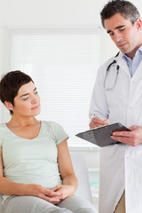 Fototapeta premium Male Doctor and female patient looking at a chart