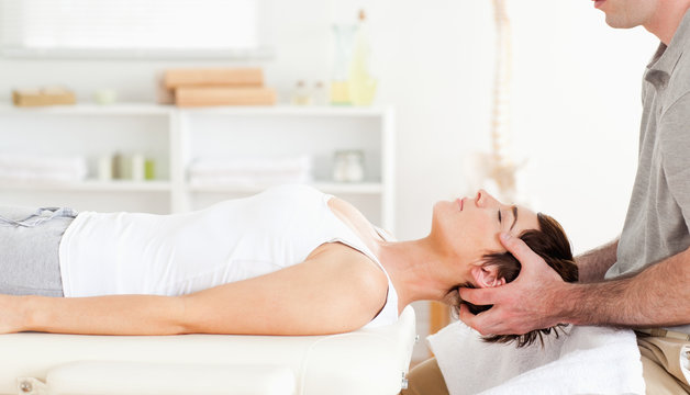 Chiropractor stretching a cute woman