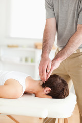 Fototapeta na wymiar Guy massaging a radiant woman's neck