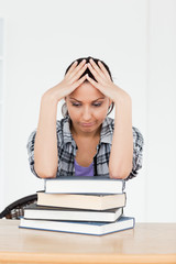 Depressed young  student resting on books