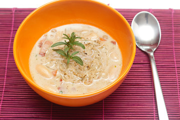 fresh lentil soup in an orange bowl