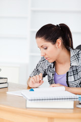 Young student learning between books