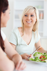 Obraz na płótnie Canvas Close up of Smiling Women eating salad