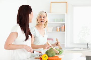 Obraz na płótnie Canvas Cheering young Women preparing dinner