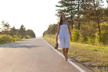 woman walking along the road