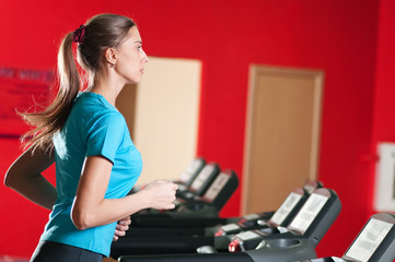 Fototapeta na wymiar Gym exercising. Run on on a machine.