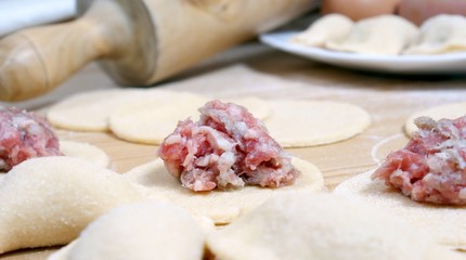 Fototapeta na wymiar preparing of pelmeni - meatballs in dough