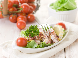 octopus salad with tomatoes and lettuce