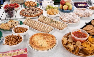 Picnic being laid out over tables