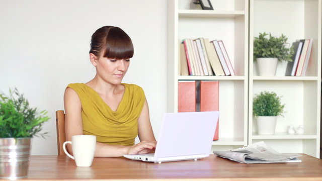 Portrait of young woman working on laptop