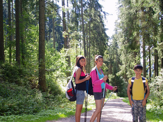 smiling kids hiking in the forest