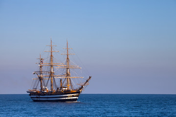 A beautiful three-masted sailboat in the sea
