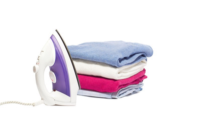 iron and a pile of clothes on a white background