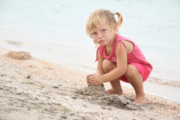 cute girl playing on beach
