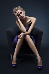 The image of a beautiful luxurious woman sitting on chair. Studi