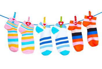 Bright striped socks on line  isolated on white
