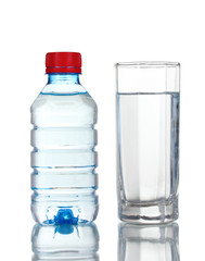One plastic bottle and glass of water isolated on white