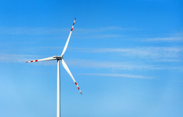 Wind turbine against blue sky