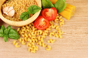 spaghetti with garlic, onion, spices  and basil on a yellow back