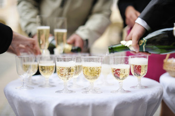 Pouring champagne into a glasses on a festive event