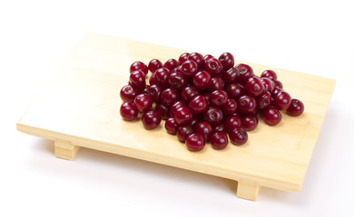 Bowl with ripe cherries. Isolated on a white background.