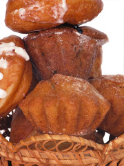 Donuts and rolls lie in wattled in a basket