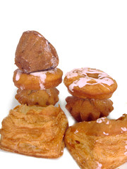 Donuts and rolls lie in wattled in a basket